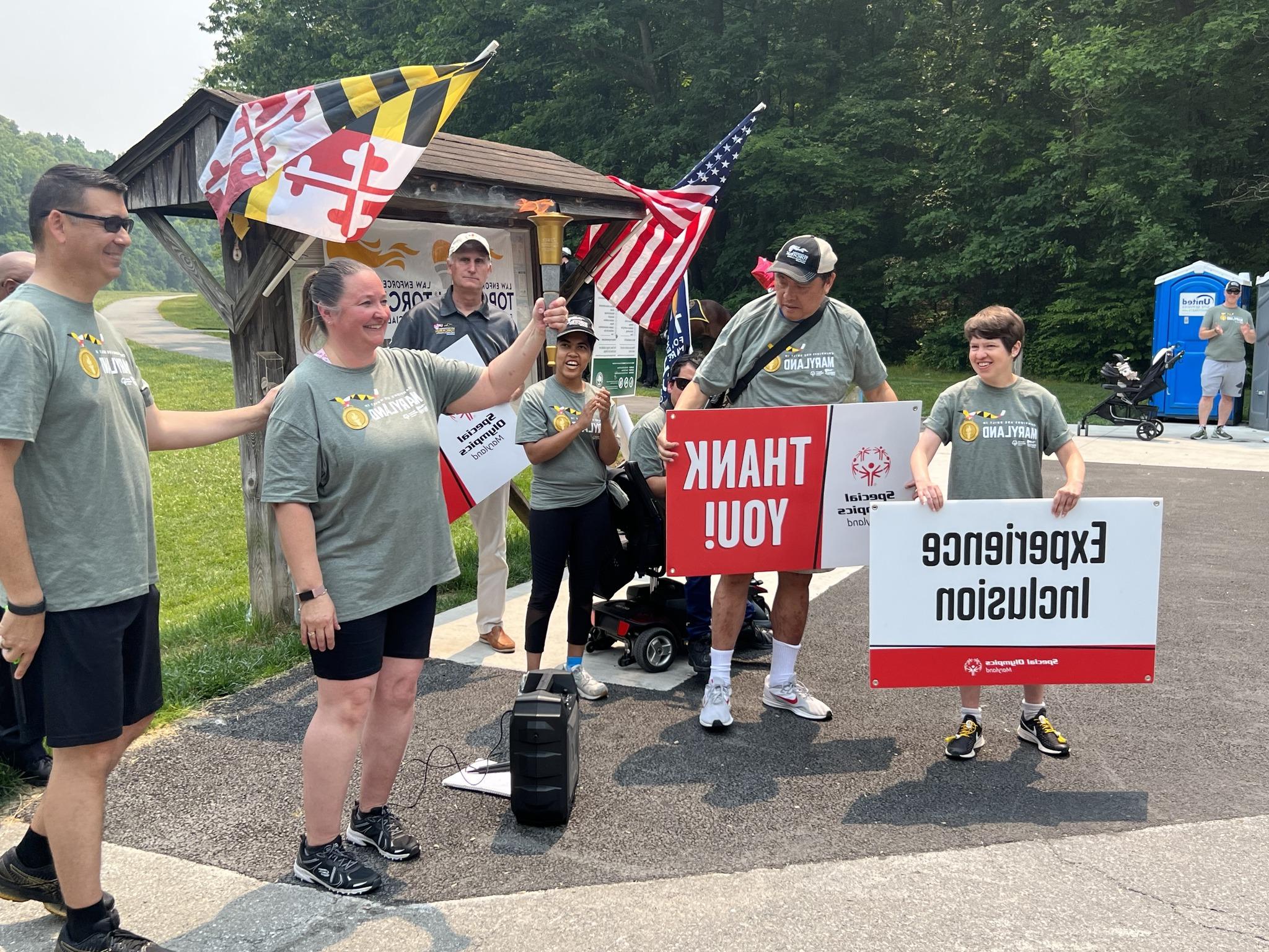 Special Olympics athletes holding the lit torch in preparation for the run.